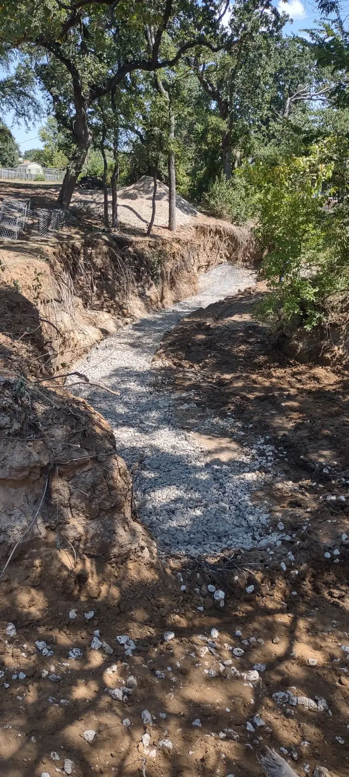 Gabion wall base along creek bank